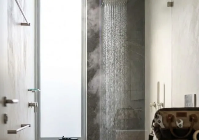 Gas continuous flow vs electric tank hot water systems compared for shower performance in a Sydney bathroom.