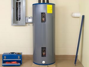 A large grey water heater with rust stains on the side, indicating potential water quality issues.