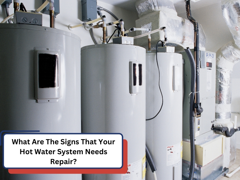 Multiple hot water systems need repair in a utility room.