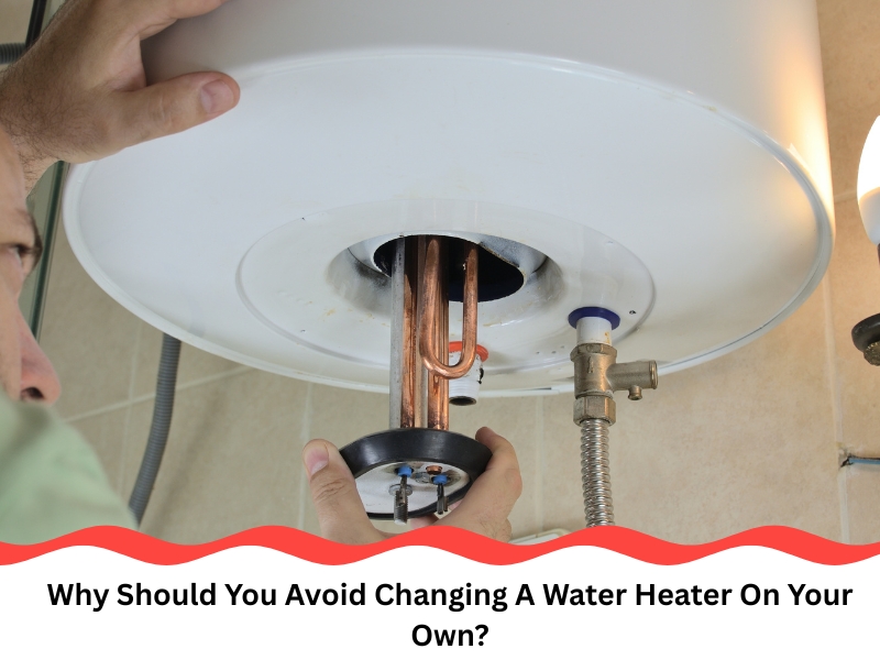 A man working inside the base of a unit while changing a water heater without assistance