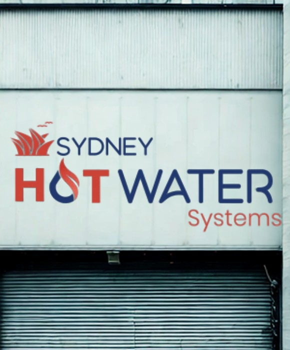 Our Process – Sydney Hot Water Systems logo with a stylised flame and Sydney skyline, displayed on a building facade.