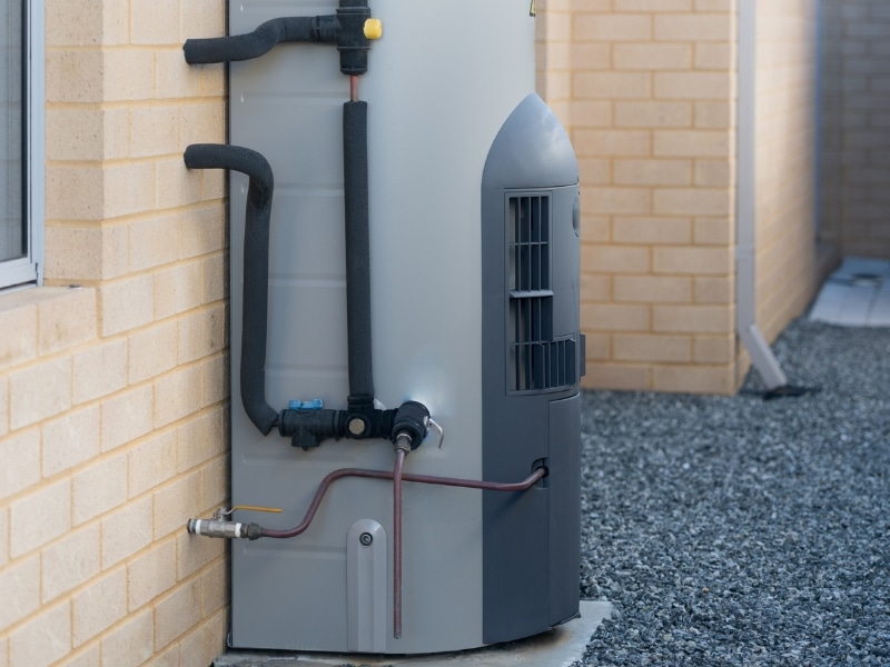 Outdoor tank used when installing gas hot water system on brick wall