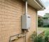 Outdoor gas hot water system beside a residential home with visible flue, ventilation clearance, gas connection and safety-compliant installation in Sydney.