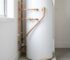 Ageing residential hot water system with minor water pooling at the base in a clean Australian home utility area.