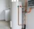 Modern hot water system in a Sydney home utility area with visible plumbing and a small water leak for troubleshooting.